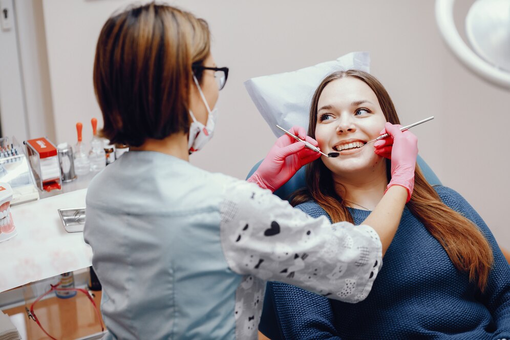 Patient receiving root canal treatment with dentist explaining pain management steps